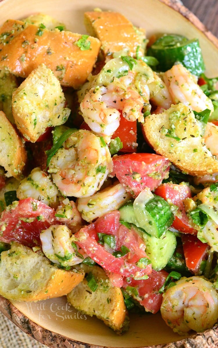 Top view Panzanella Salad with Shrimp, tomato, and cucumber, and bread with Pesto in a bowl 