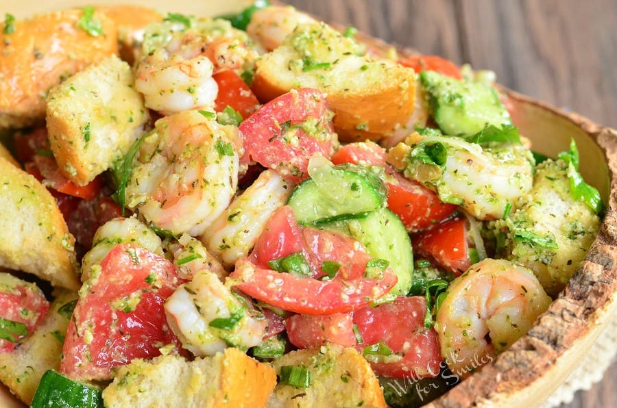 Panzanella Salad with Shrimp, tomato, and cucumber, and bread with Pesto in a bowl 