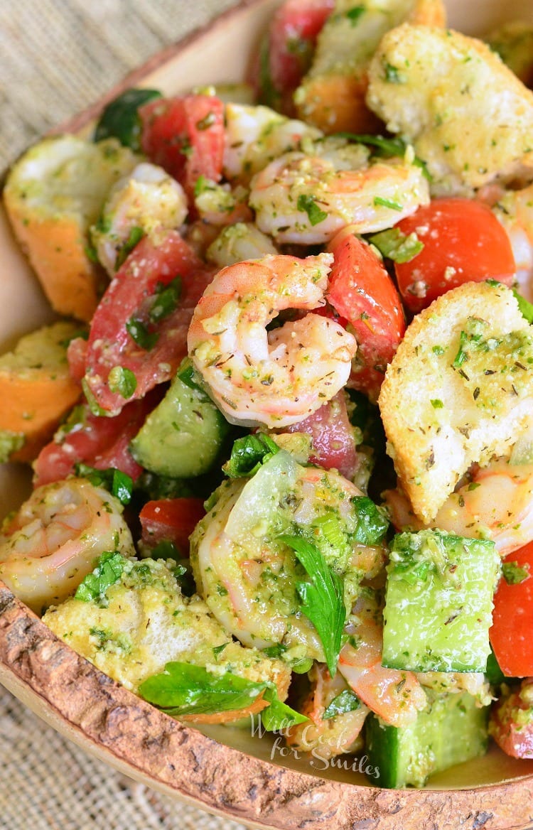 Panzanella Salad with Shrimp, tomato, and cucumber, and bread with Pesto in a bowl 