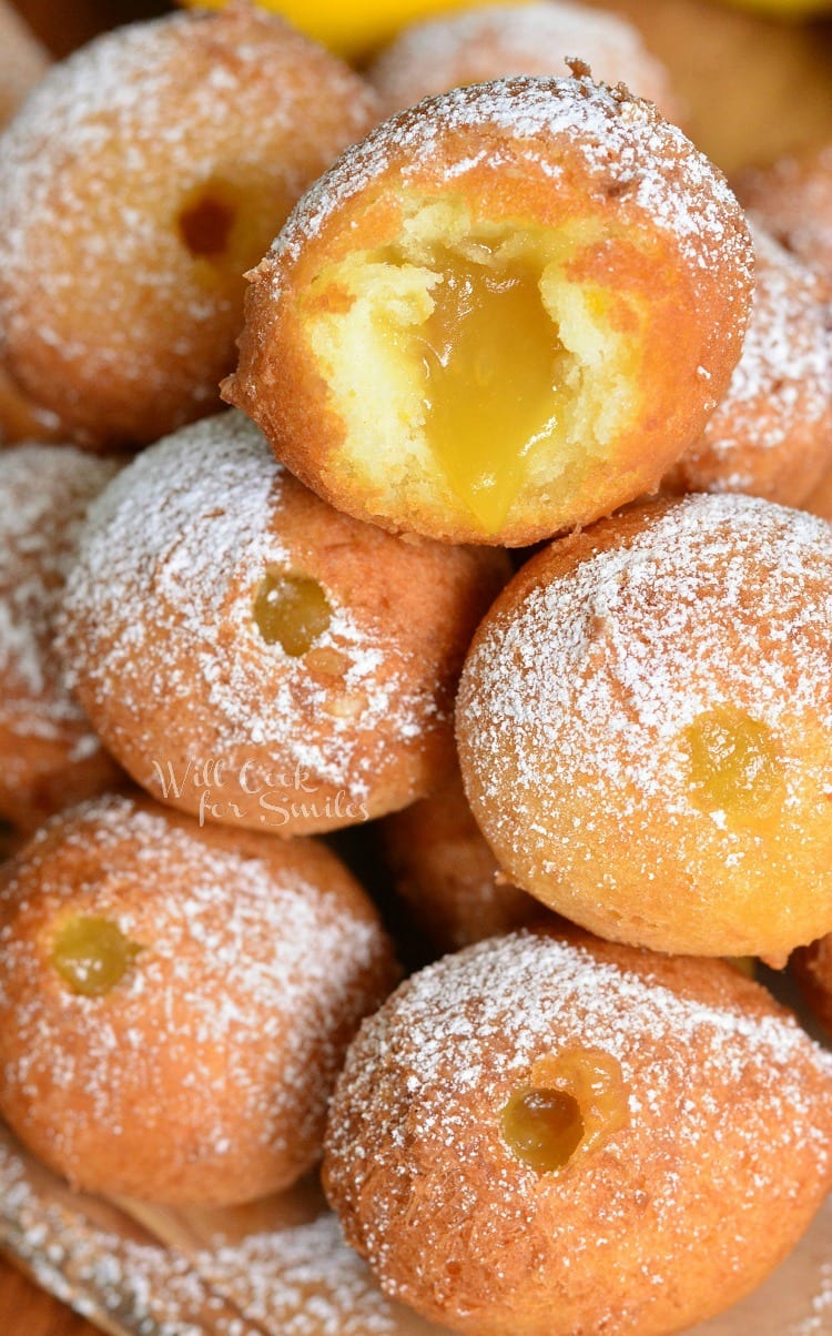 Lemon Curd Filled Doughnut Holes stacked up with one cut open 