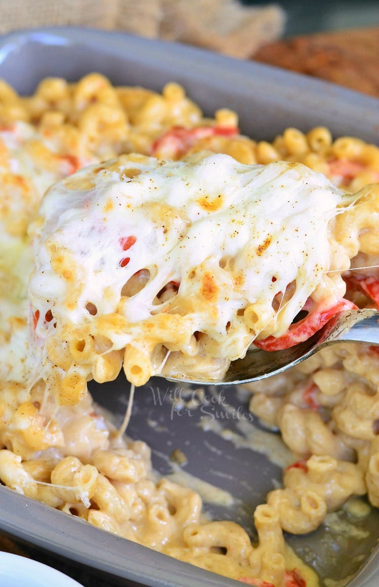 Po'Boy Mac and Cheese being lifted out of serving pan with a big metal serving spoon 