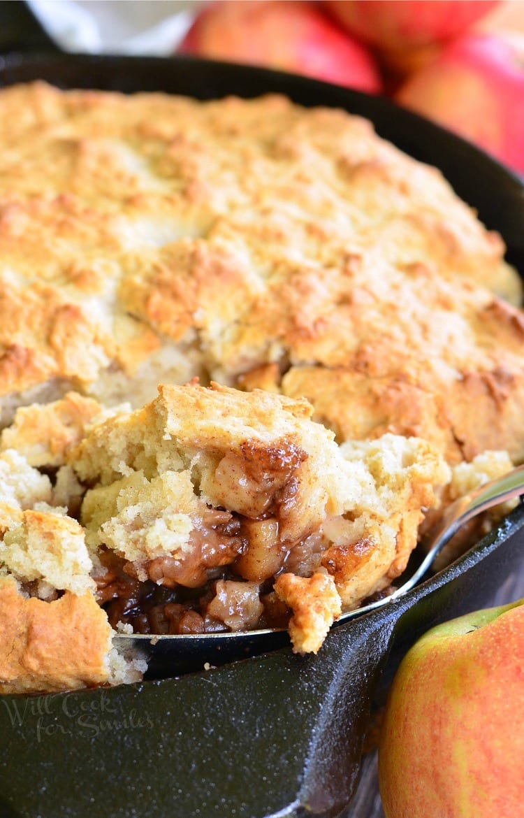 scooping Maple Pecan Apple Cobbler out of Skillet with a spoon 