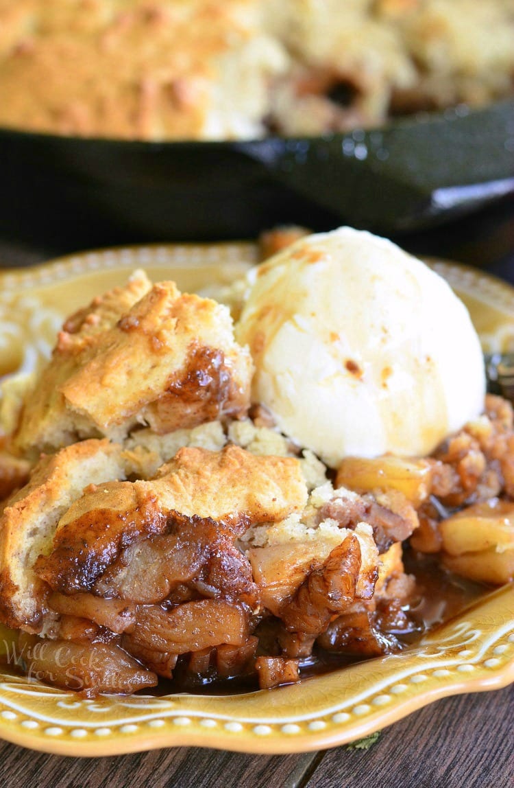 Maple Pecan Apple Cobbler Skillet with a scoop of vanilla ice cream on a yellow plate