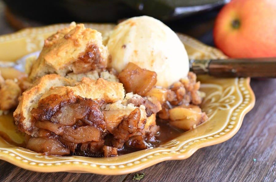 Maple Pecan Apple Cobbler Skillet with a scoop of vanilla ice cream on a yellow plate 