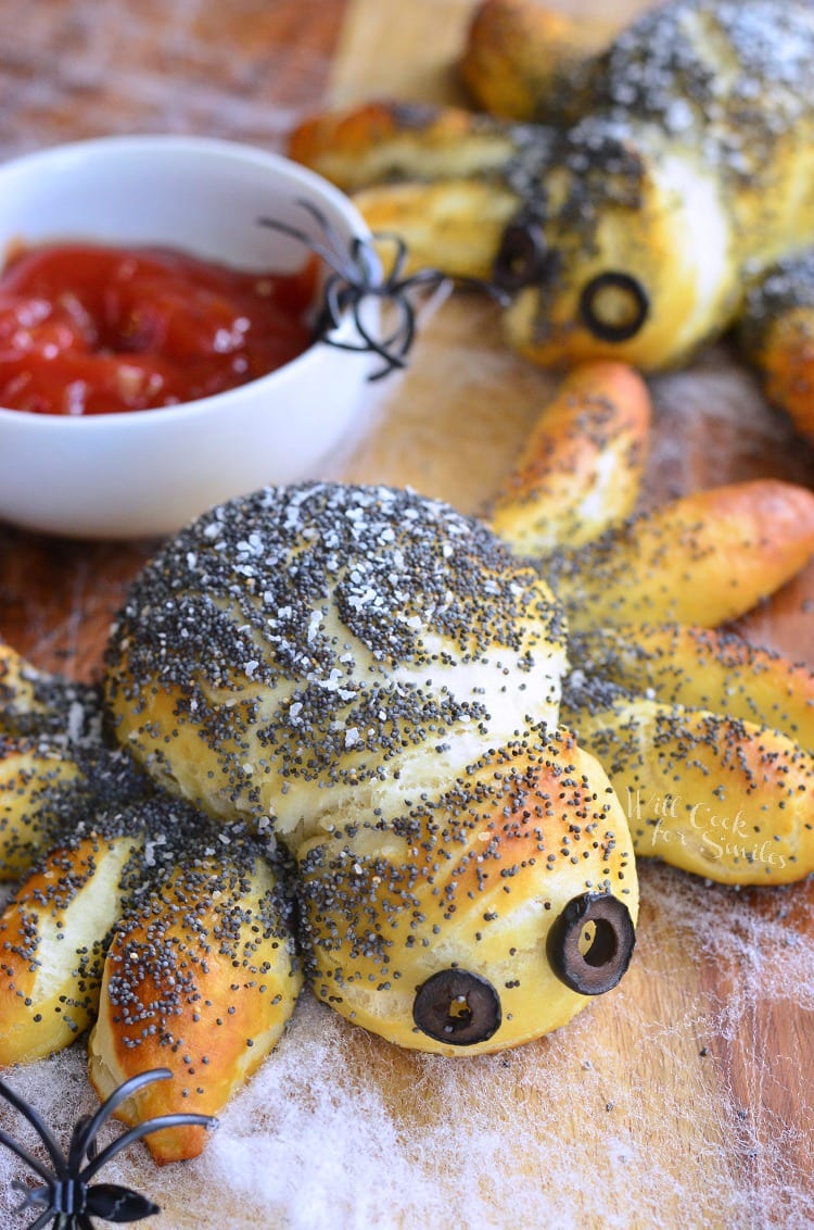 Pretzel Spiders with black olive eyes and red dipping sauce 