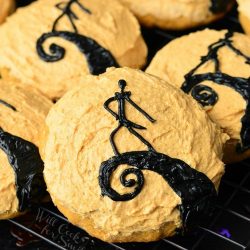 Decorative cookies in the design of "The Nightmare Before Christmas" on a cooling rack as seen from above.