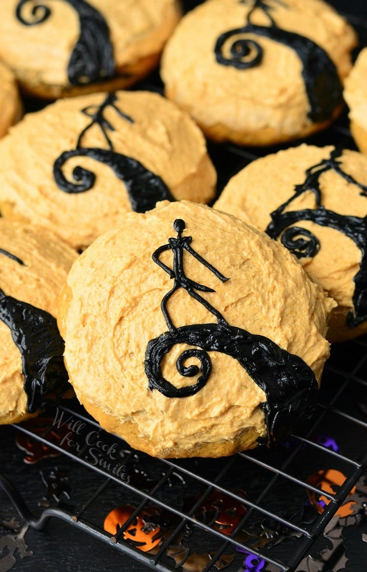 The Nightmare Before Christmas Cookies close up Orange frosted cookies some with Jack and one with Jack on a cooling rack 