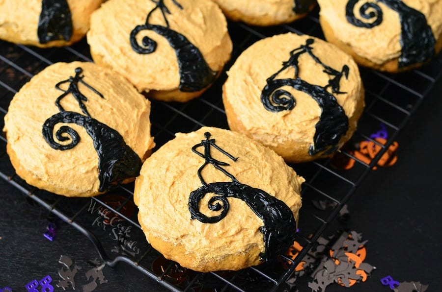 The Nightmare Before Christmas Cookies top view Orange frosted cookies some with Jack and one with Jack and Sally together on a cooling rack 