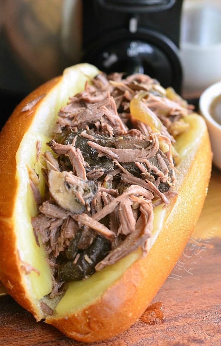 Mushroom and Onion Italian Beef sub on a cutting a board 