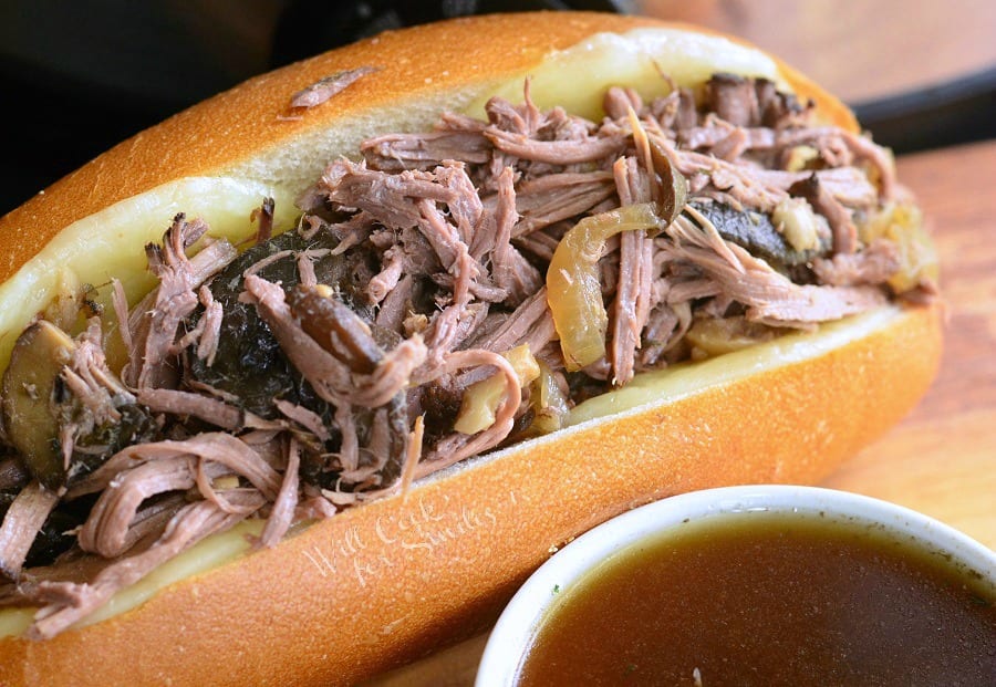 Mushroom and Onion Italian Beef sub with au jus sauce in a small white bowl 