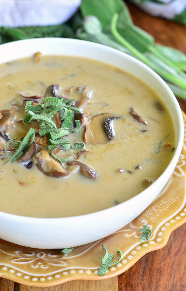 Mushroom Soup in a white bowl topped with fresh sage