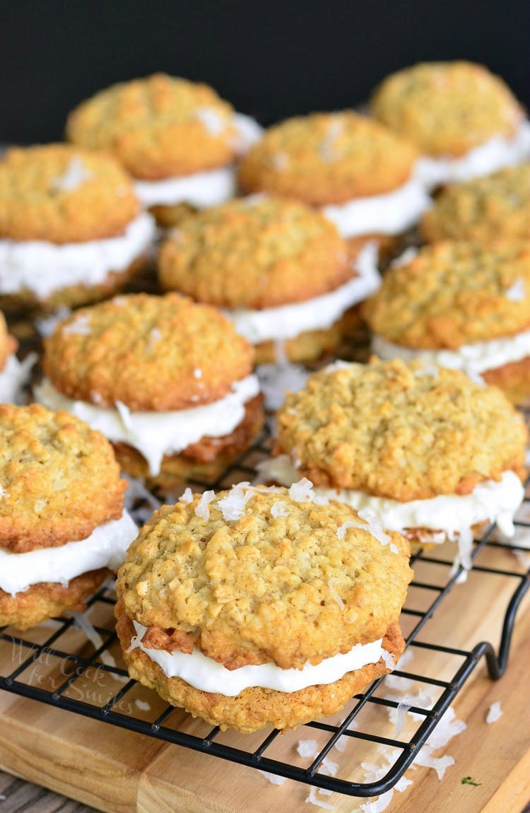 Coconut Oatmeal Cookie Sandwich on a cooling rack that is on a wood cutting board 