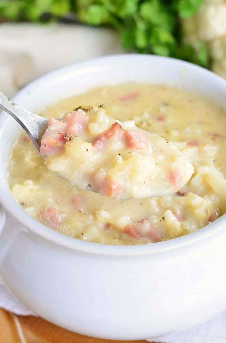 cauliflower and ham soup on a metal spoon pulled out of the soup bowl