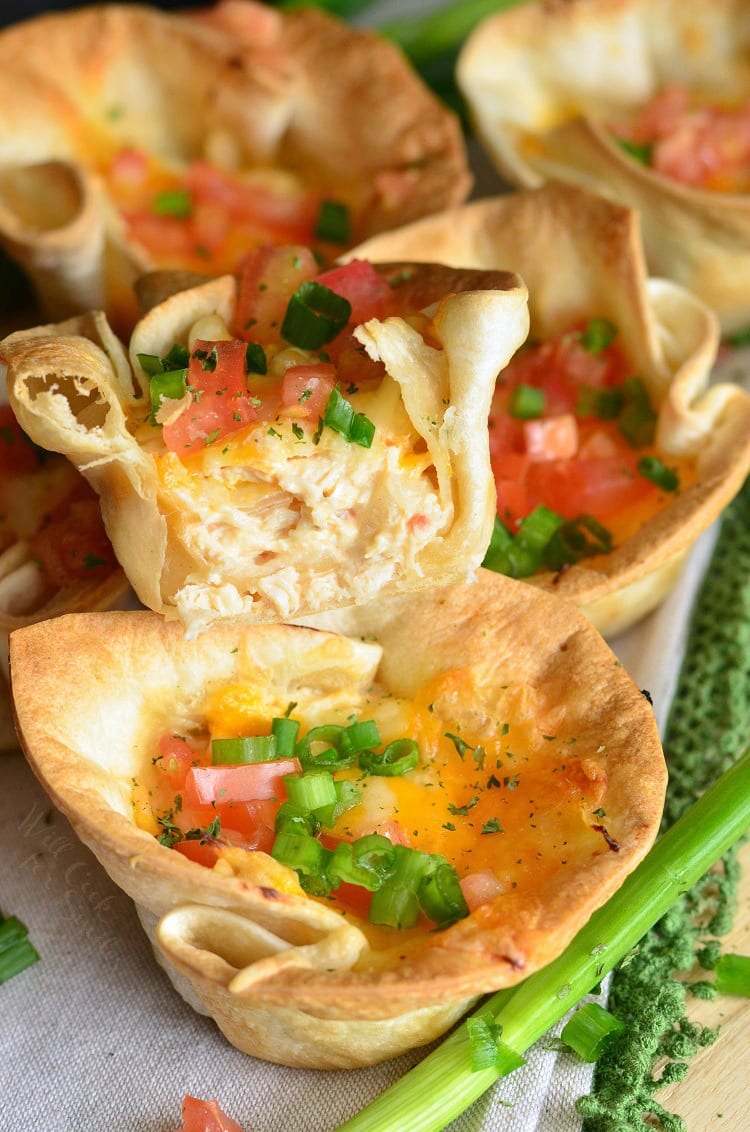 Chicken enchilada cups with stacked on top of each other with one cut in half