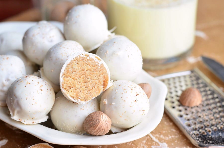 Eggnog Cookie Balls stacked in a white bowl with nutmeg 