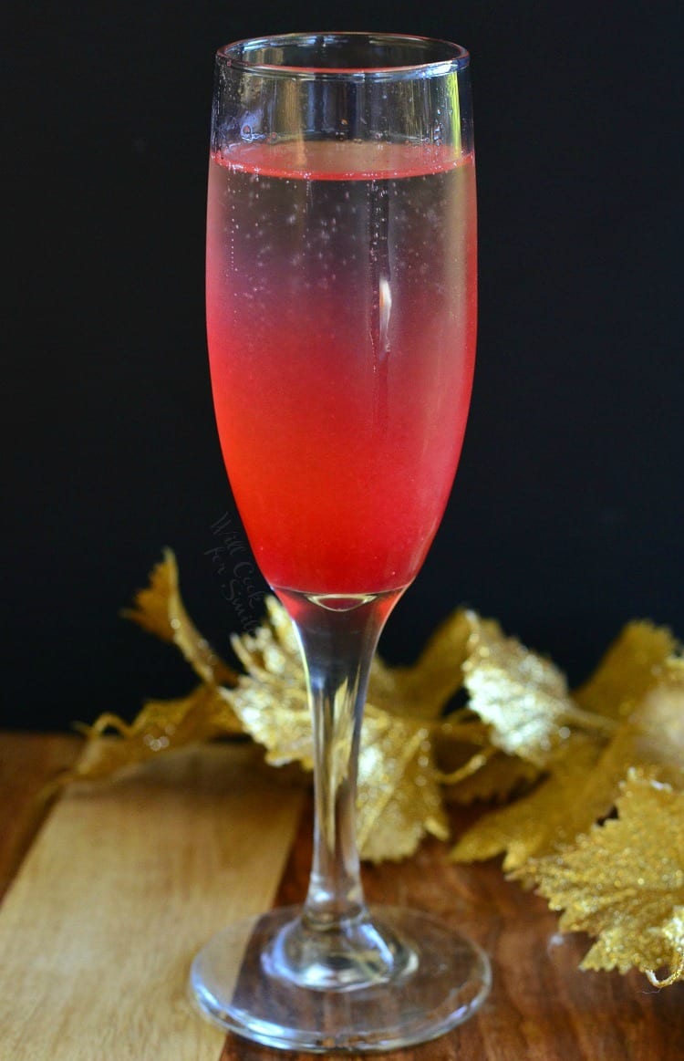 Raspberry Italian Soda Champagne Cocktail in a champagne flute on a table 