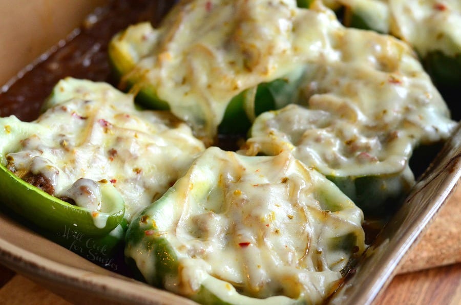 Salisbury Steak Stuffed Peppers with cheese on top in a brown casserole dish 