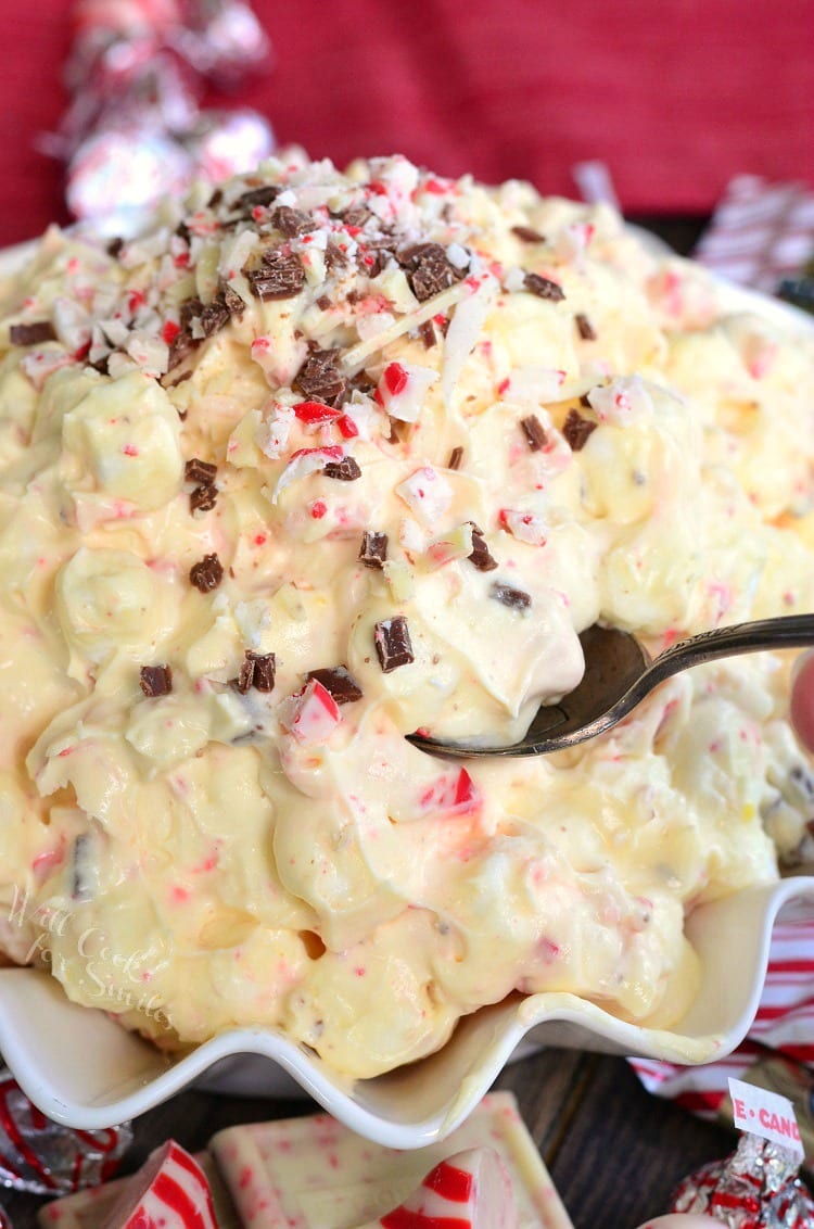 White Chocolate Peppermint Fluff Salad with a spoon in a white bowl 