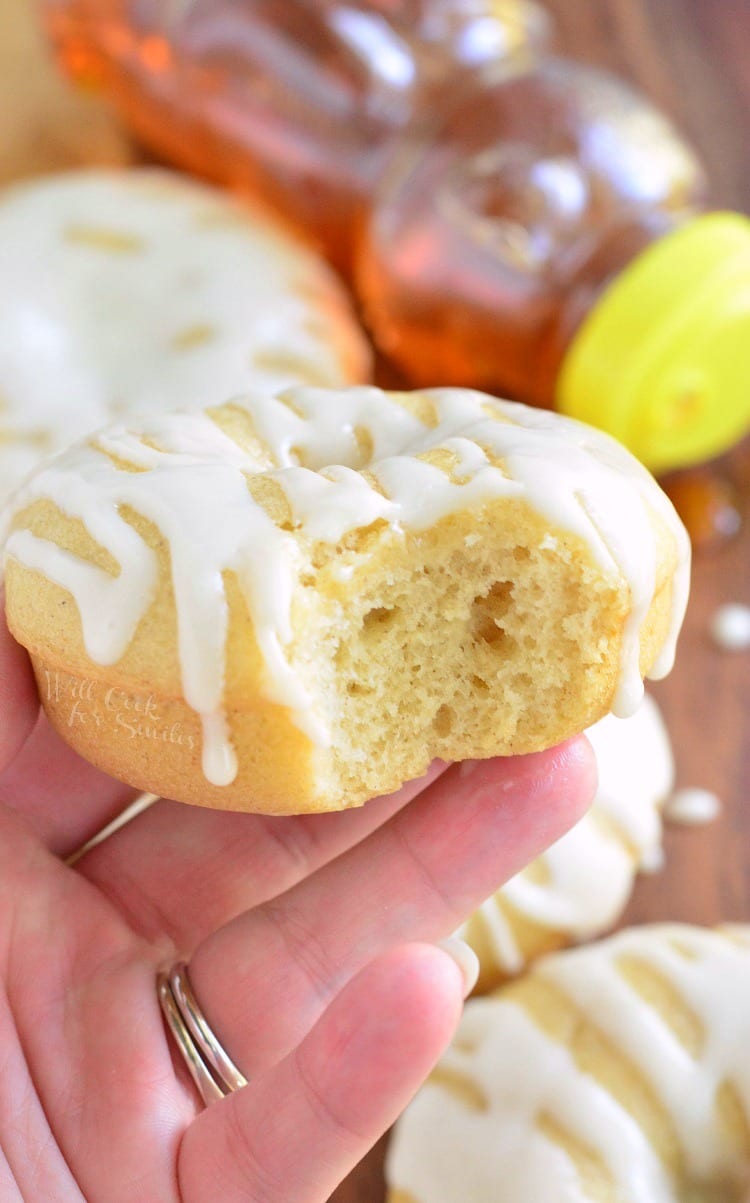 holding a Honey Doughnut with a bite out of it  