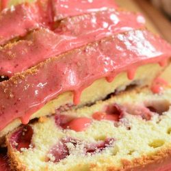 close up of strawberry pound cake with strawberry glaze cut into slices.