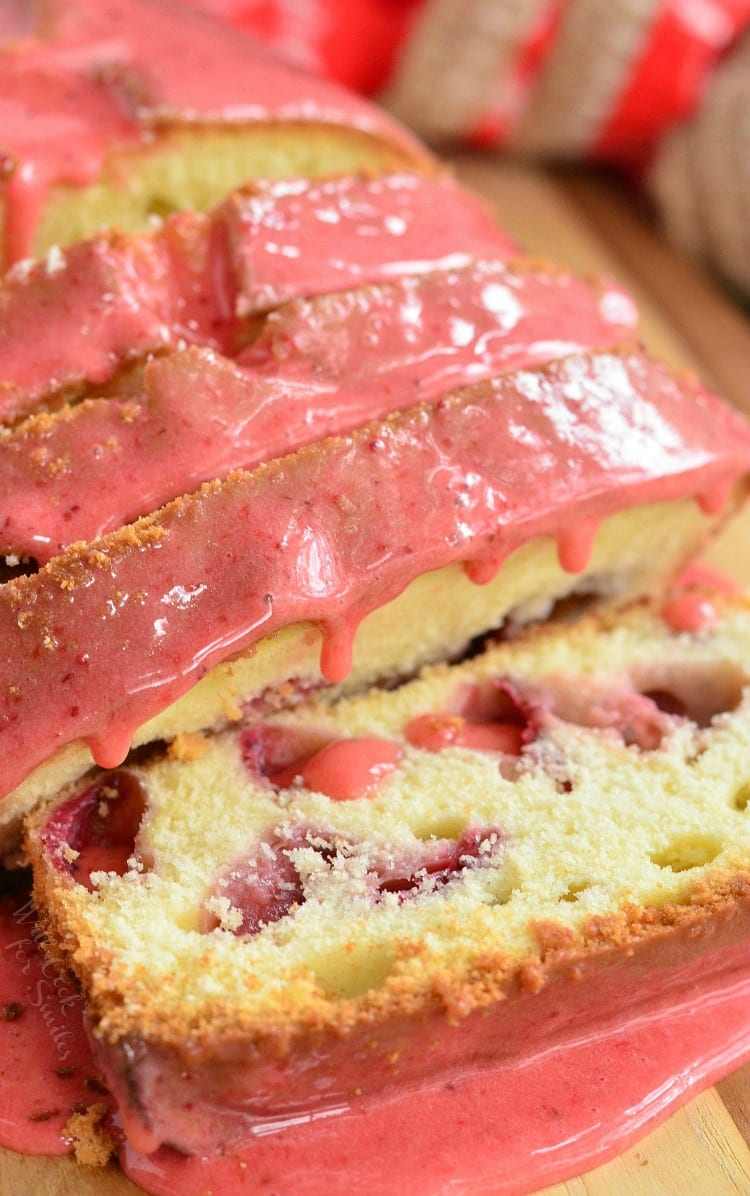 close up of strawberry pound cake with strawberry glaze cut into slices.