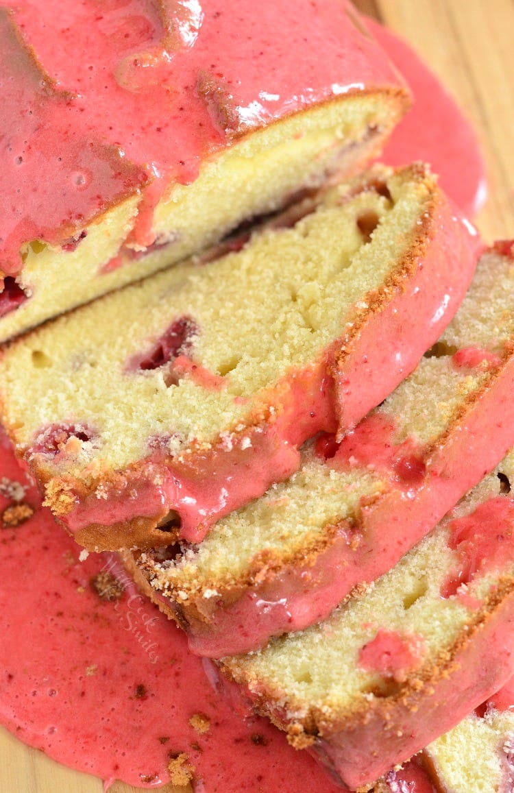 top view of Glazed Strawberry Pound Cake sliced on a cutting board
