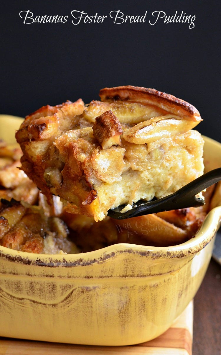 Bananas Foster Bread Pudding in a yellow baking sheet with a slice being lifted out with a spatula 