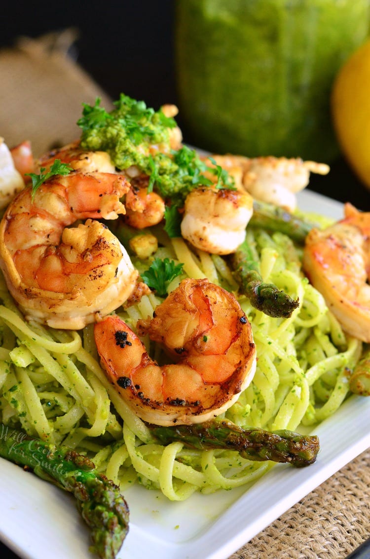 Lemon Pistachio Pesto Pasta with Shrimp and Asparagus on a white plate 