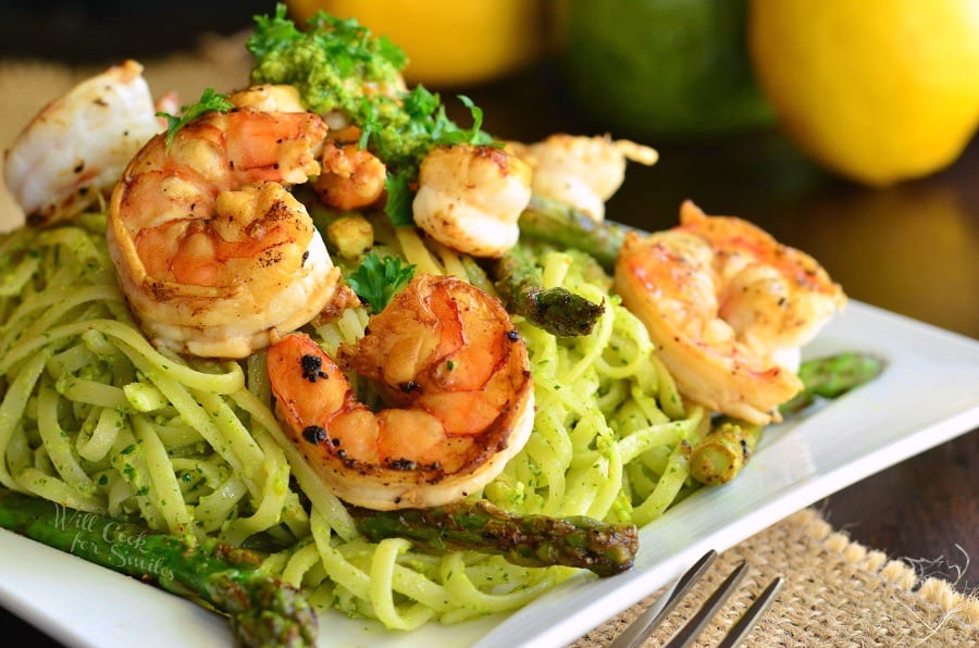 Lemon Pistachio Pesto Pasta with Shrimp and Asparagus on a white plate 