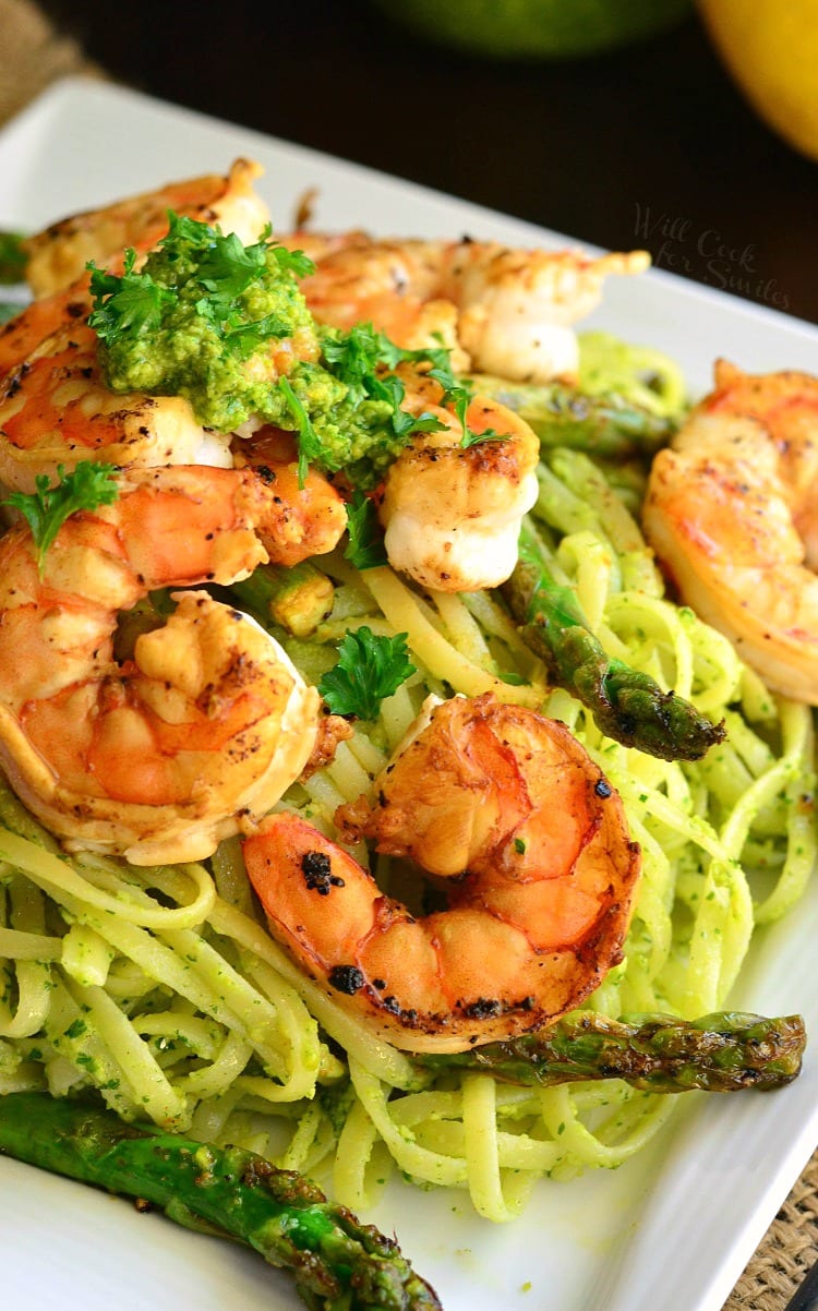 Lemon Pistachio Pesto Pasta with Shrimp and Asparagus on a white plate 