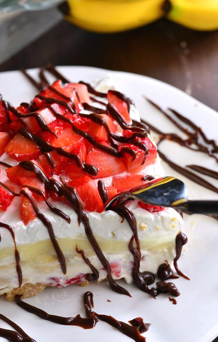 Banana Split Layered Cheesecake Dessert on a plate with a fork 