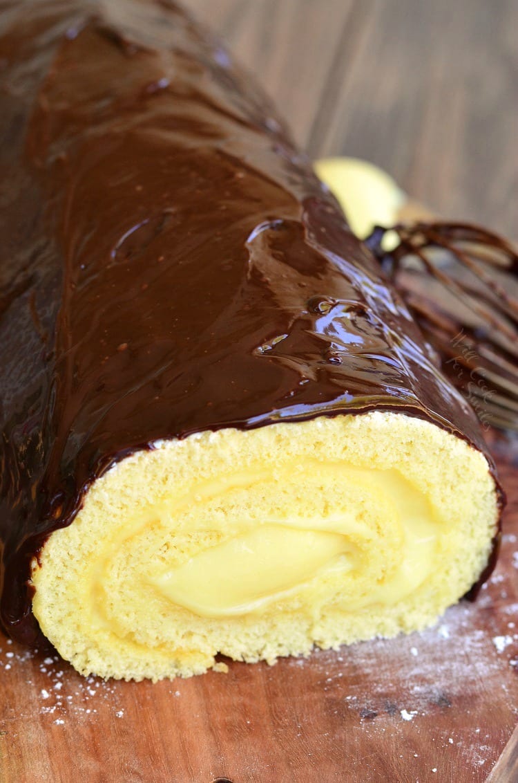 Boston Cream Cake Roll on a wood cutting board 