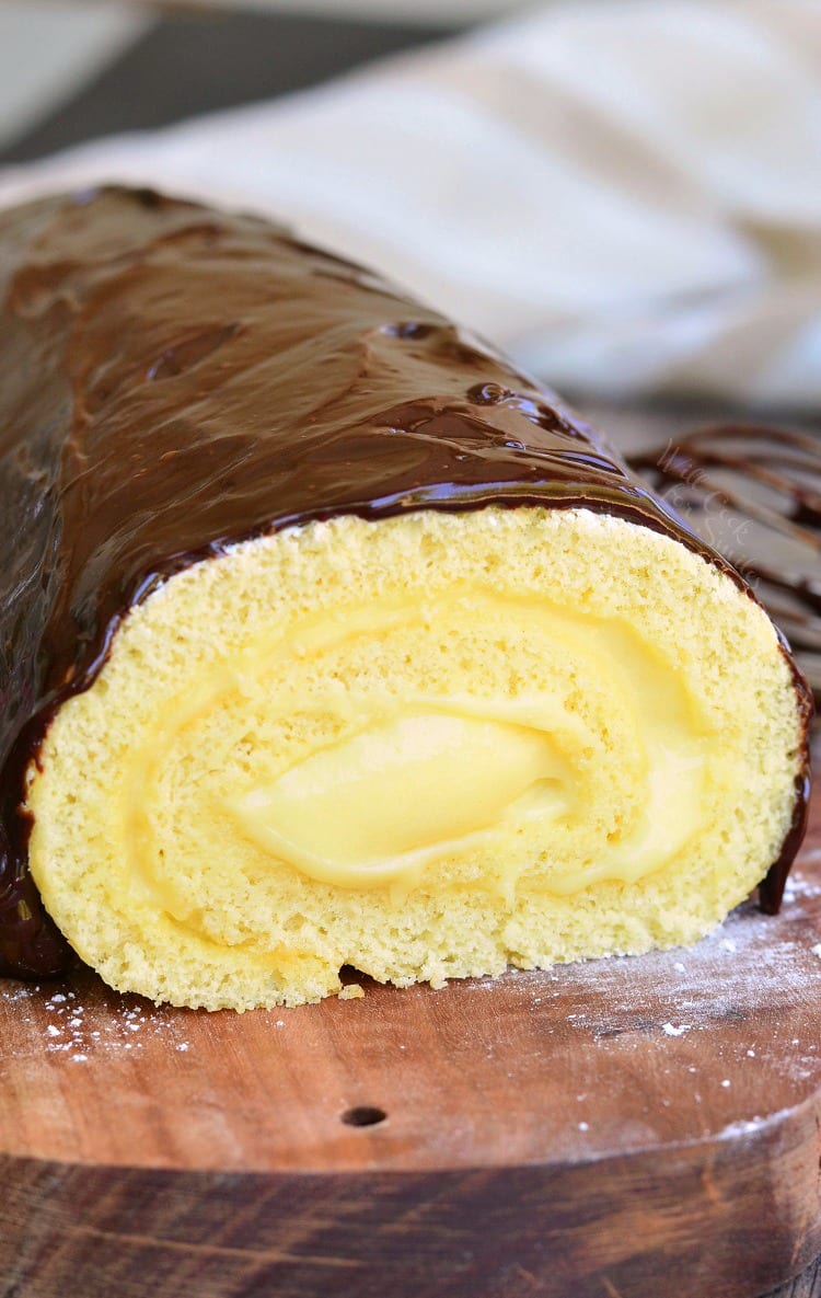 Boston Cream Cake Roll on a wood cutting board 