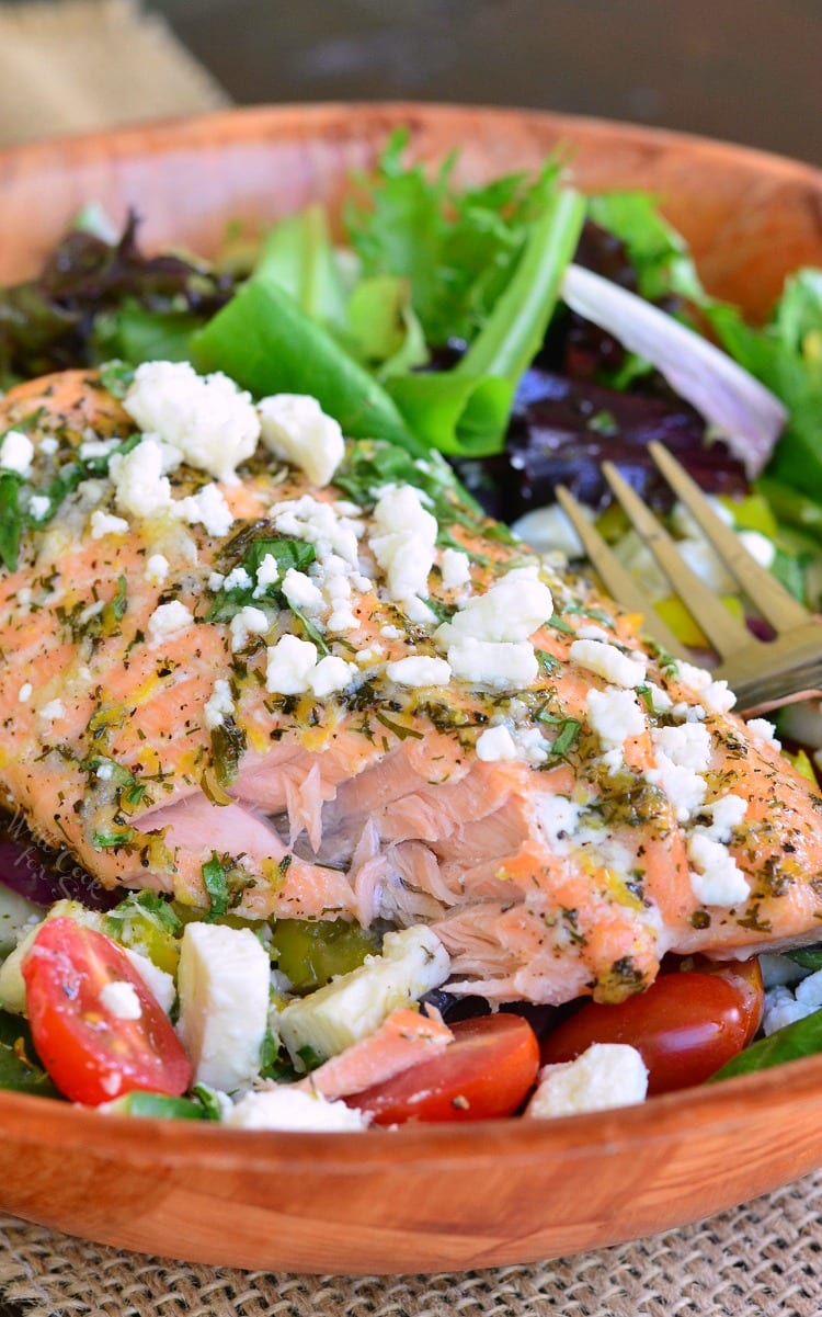 Greek Salmon Salad in a wood bowl with a fork 