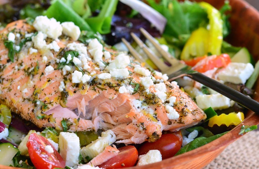 Greek Salmon Salad in a wood bowl with a fork 