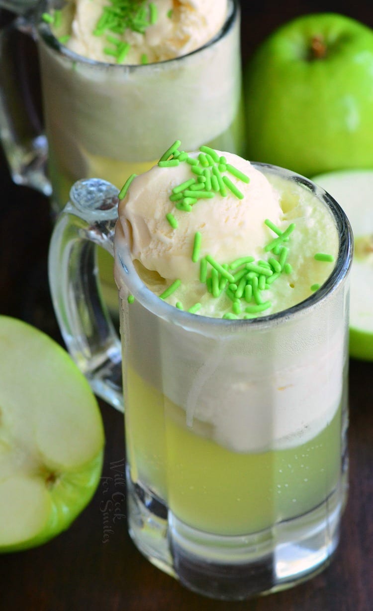 top view photo Green Apple Ice Cream Soda Float in a glass mug with apples around it 