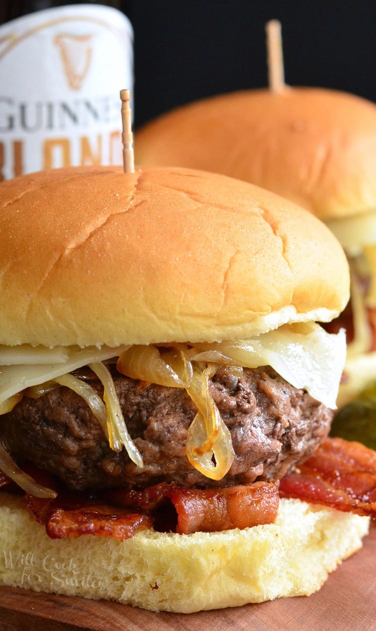 closeup of a thick burger with onions and bacon.