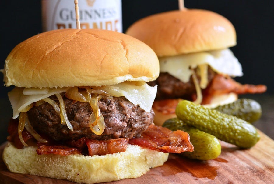 closeup of two beer burgers on cutting board.