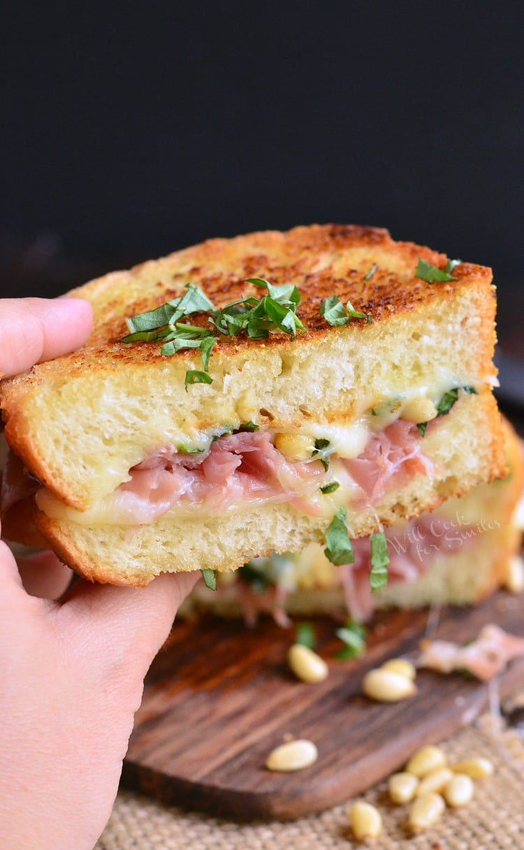 holding half of a Italian Garlic Bread Grilled Cheese with ham