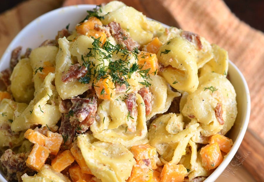top view of tortellini salad in a while bowl horizontal