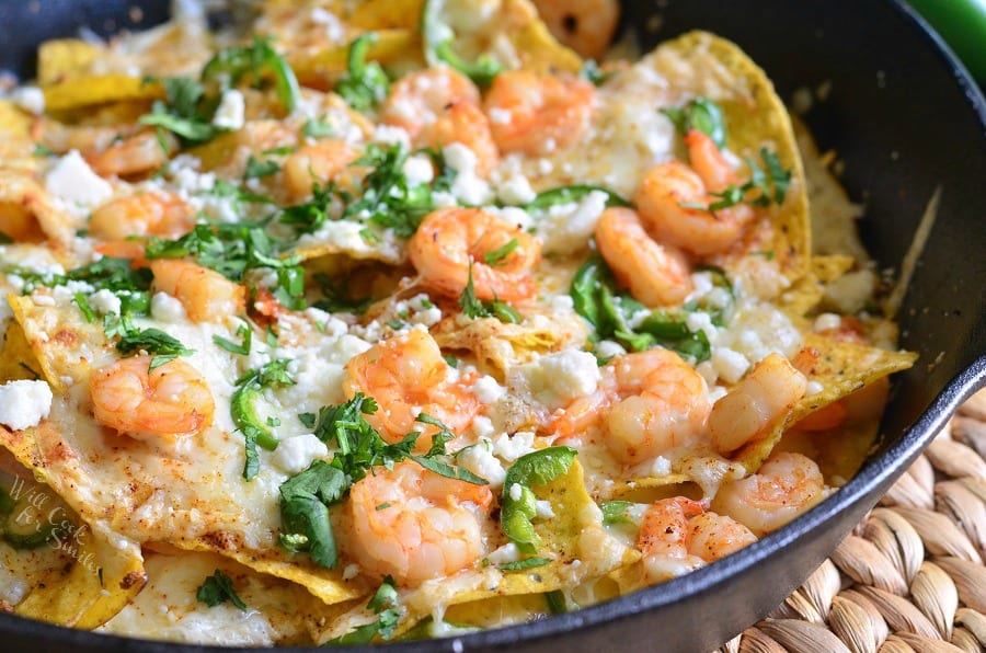 Shrimp nachos in a cast iron skillet.