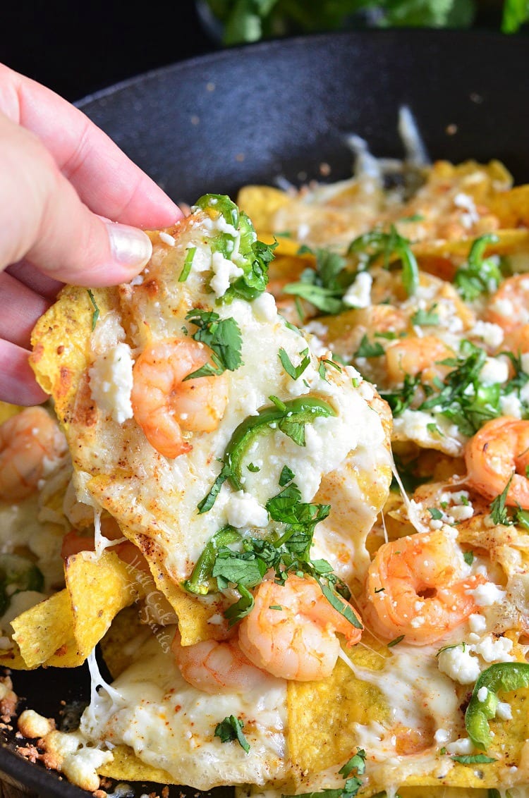 picking up Shrimp Nachos in a cast iron pan.