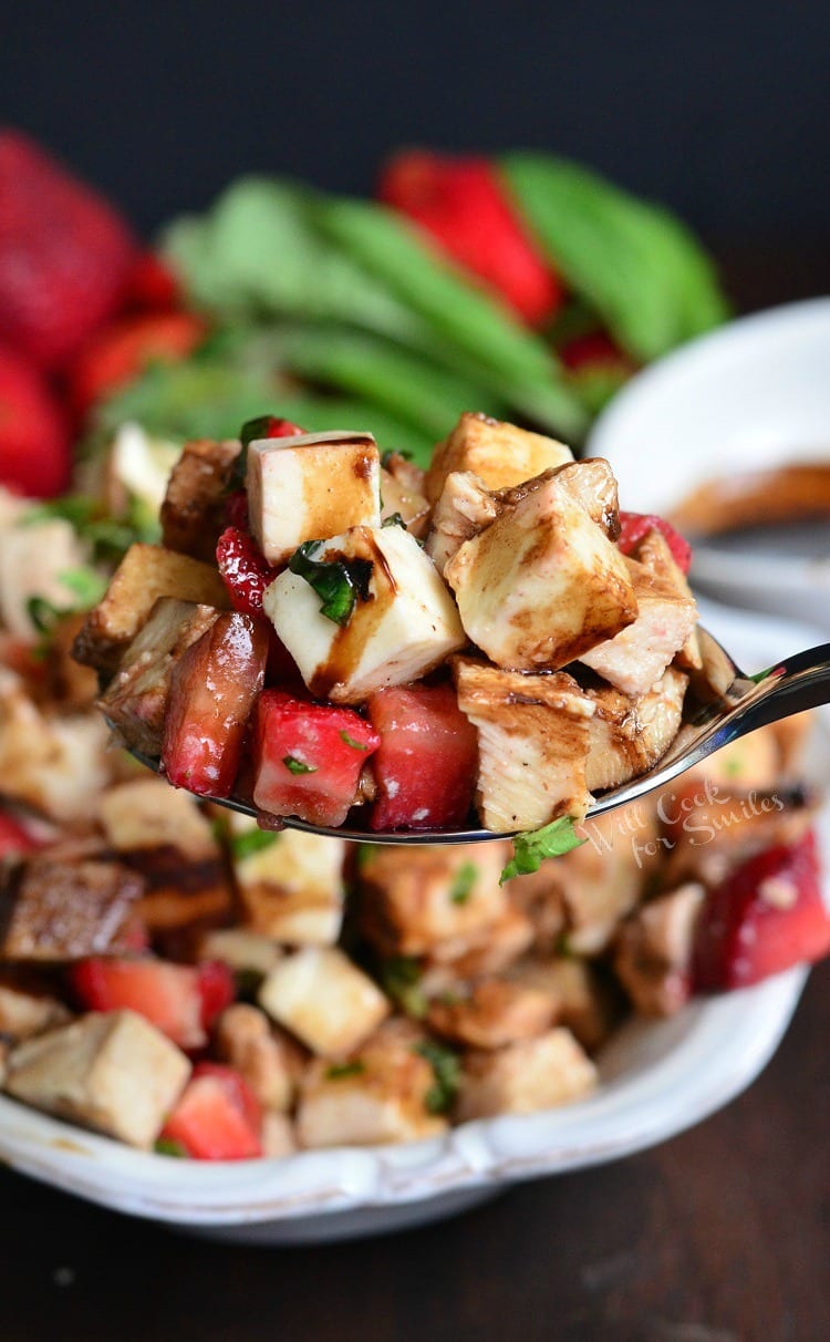 Balsamic Strawberry Chicken Salad on a spoon with the rest of the salad in the background 