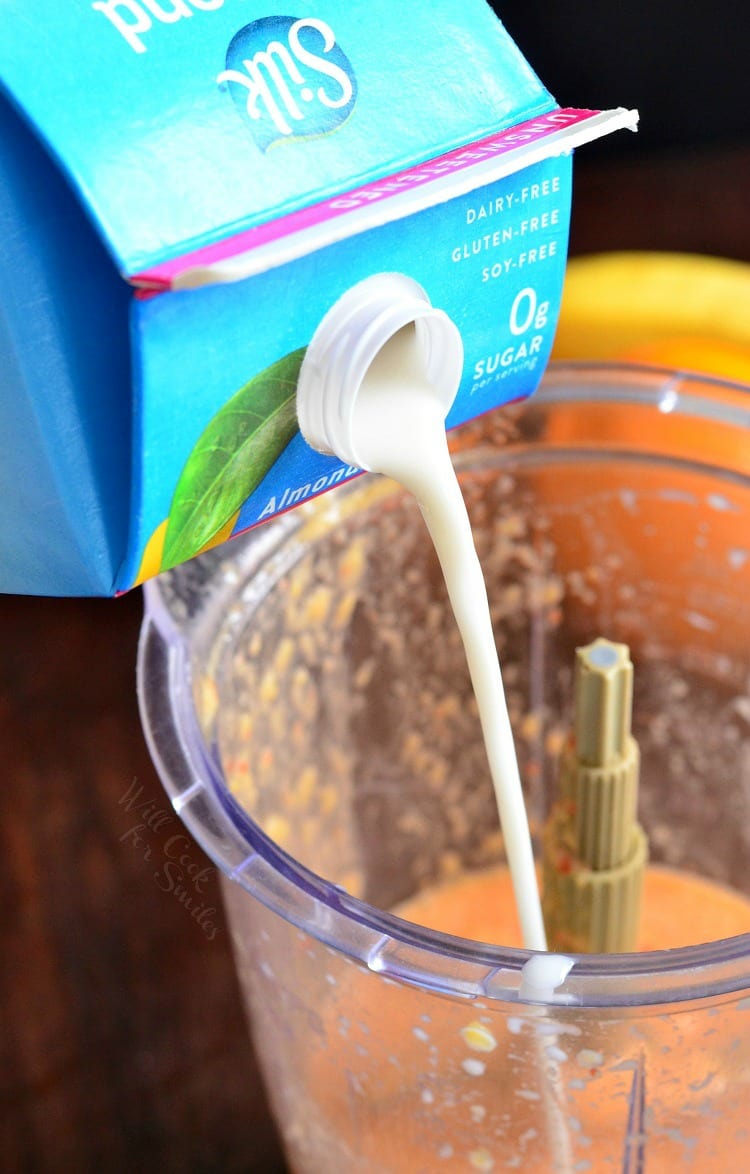 pouring silk almond milk into food processor 