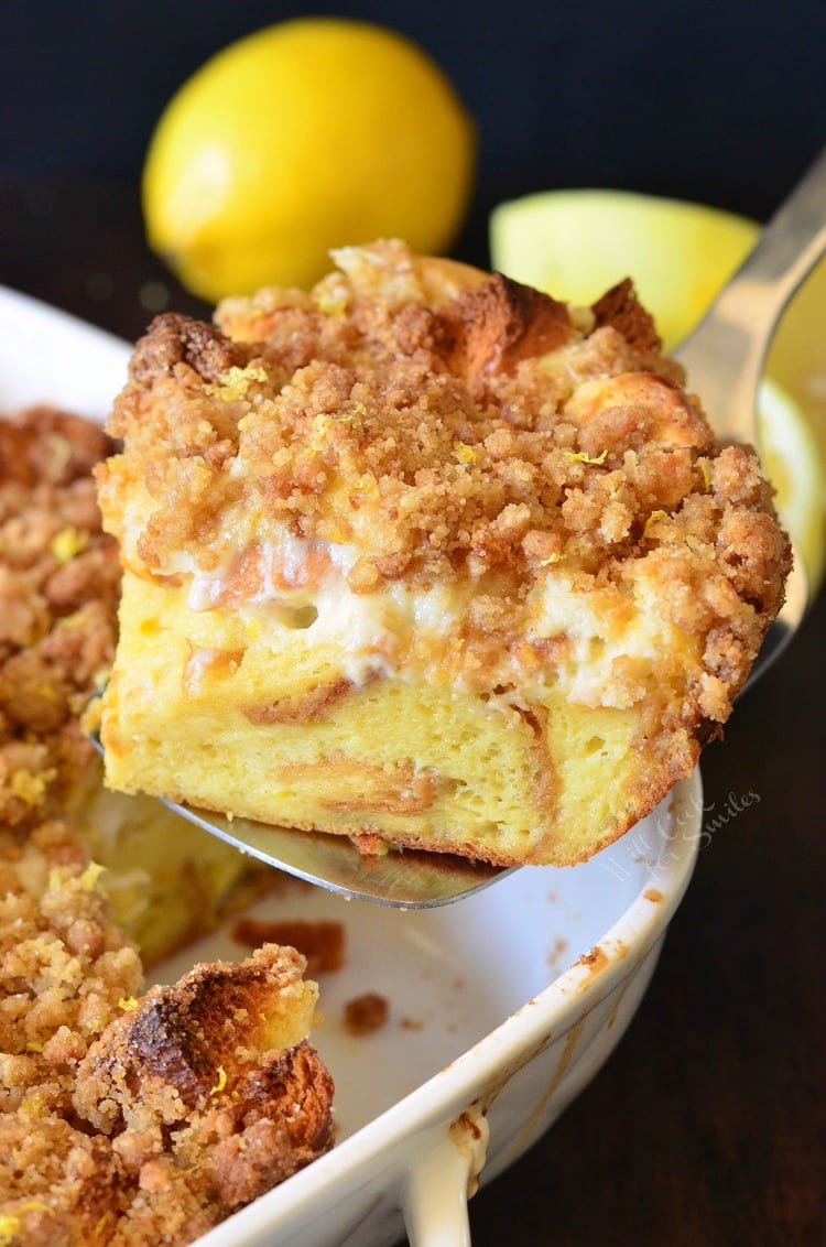 Lemon Cheesecake French Toast Casserole with a spatula lifting a slice out 