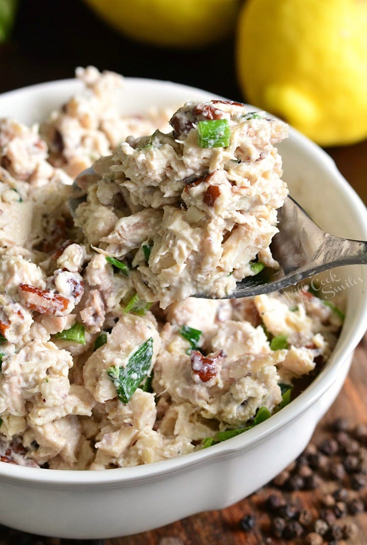 Lemon Pepper Rotisserie Chicken Salad in a white bowl with spoon scooping some out 