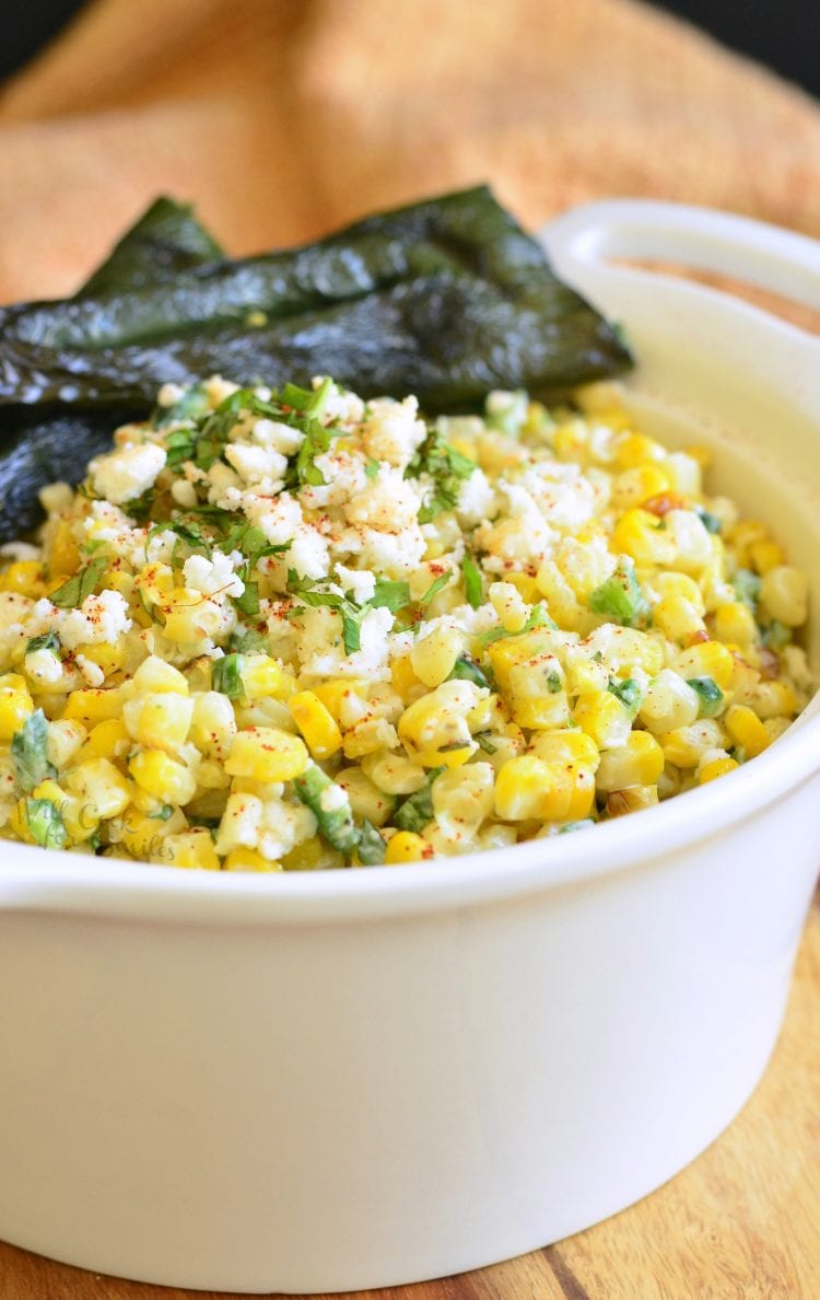 Mexican corn salad in a white bowl.