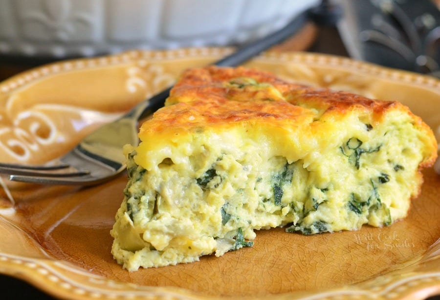 spice of spinach quiche on a brown place with a fork