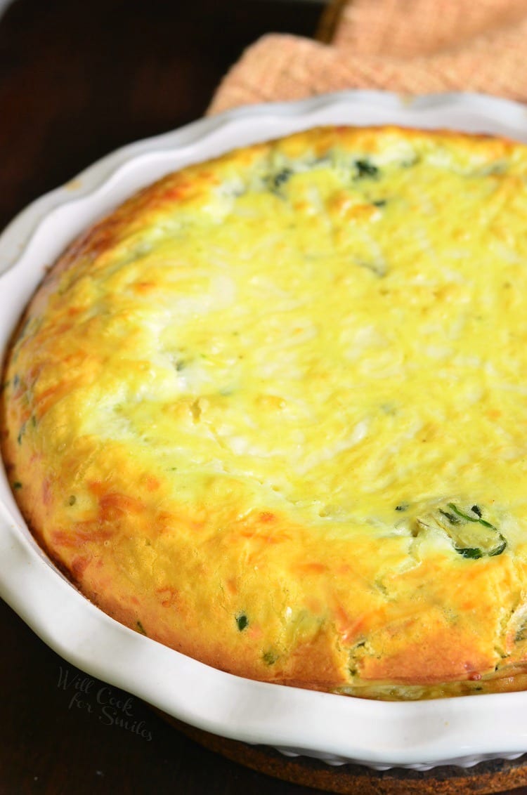 quiche just out of the oven in a white baking dish