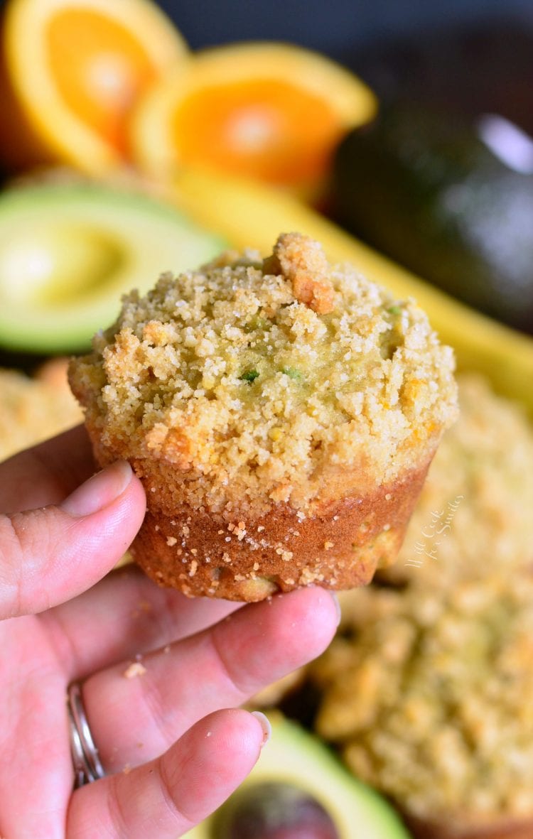 Holding a Avocado Banana Muffins with Orange Streusel